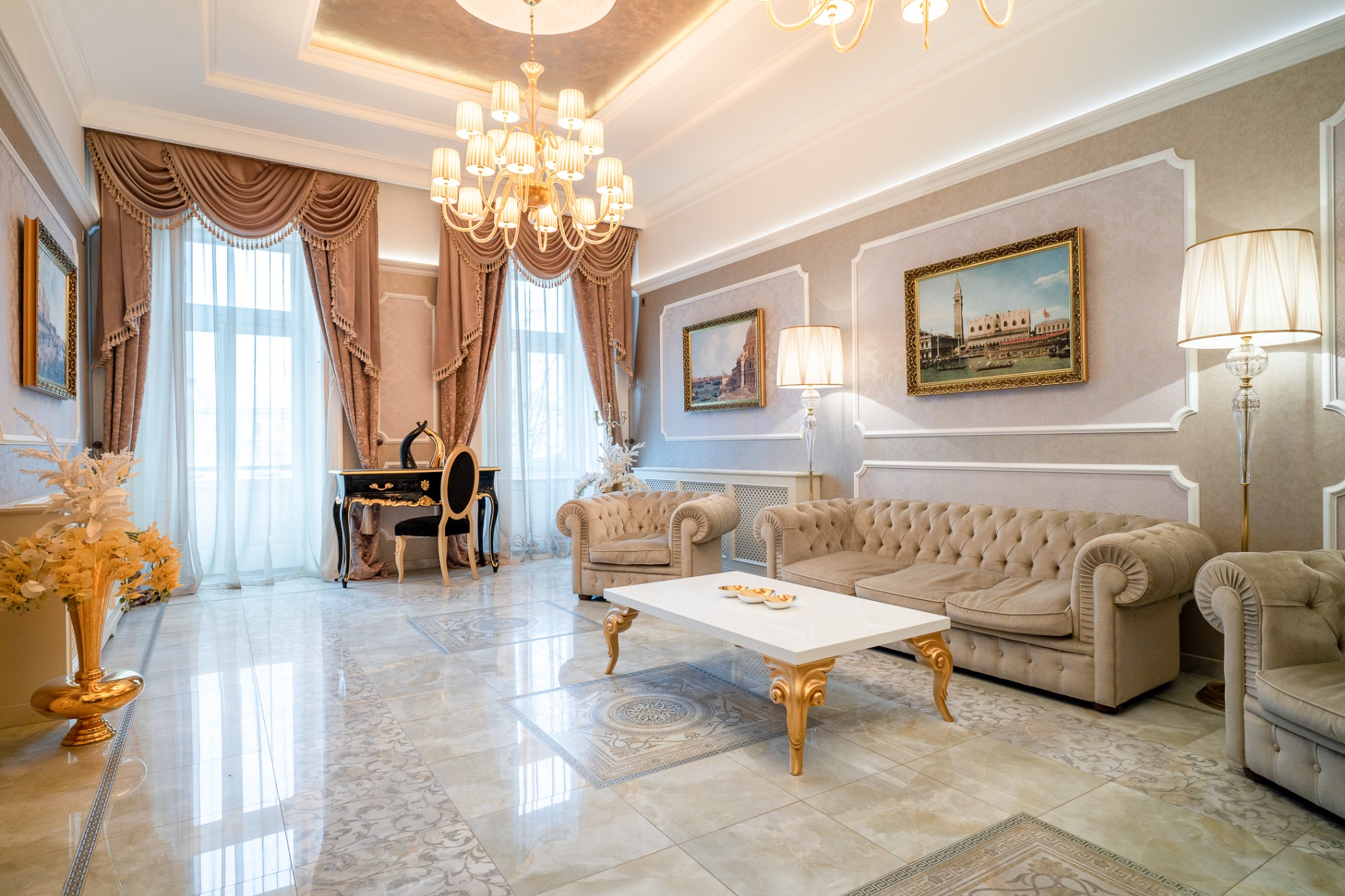 Elegant living room with chandeliers, a sofa and a white table, photographed by Cristian Muntean