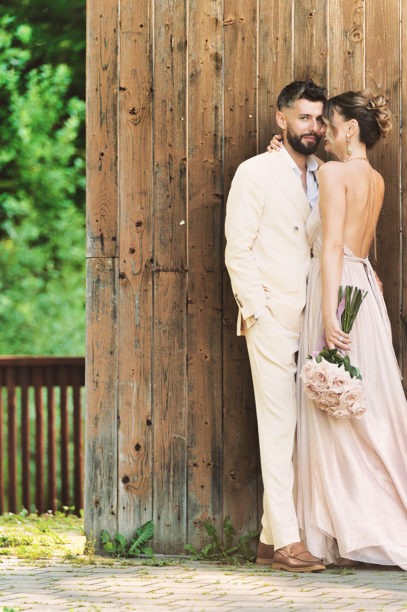 Couple beside a wooden architectural structure