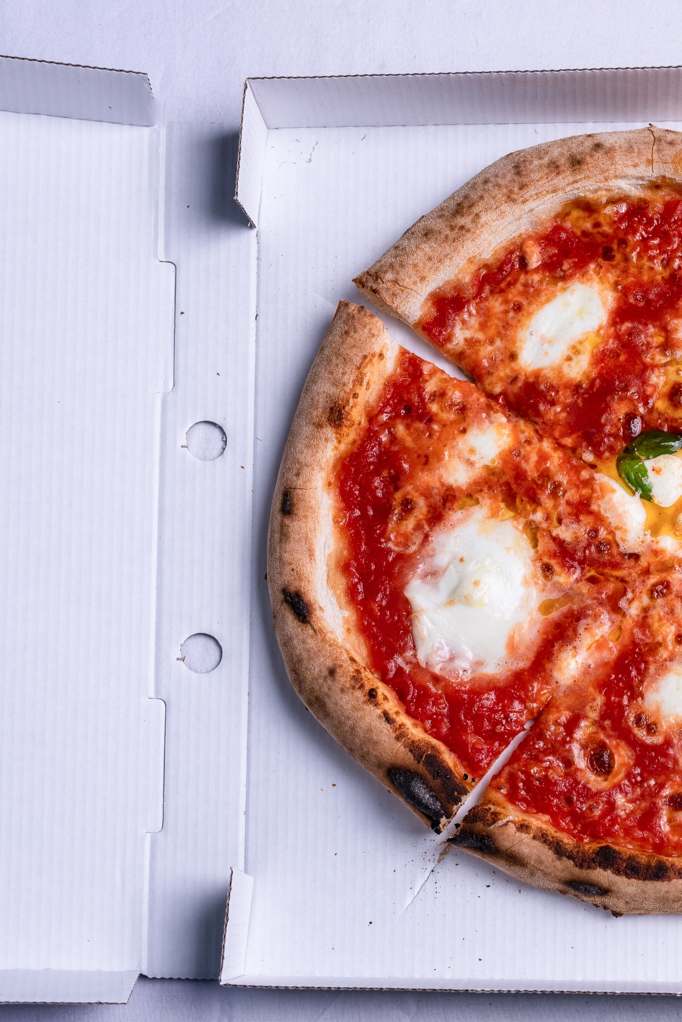 Tomato and cheese pizza in a box