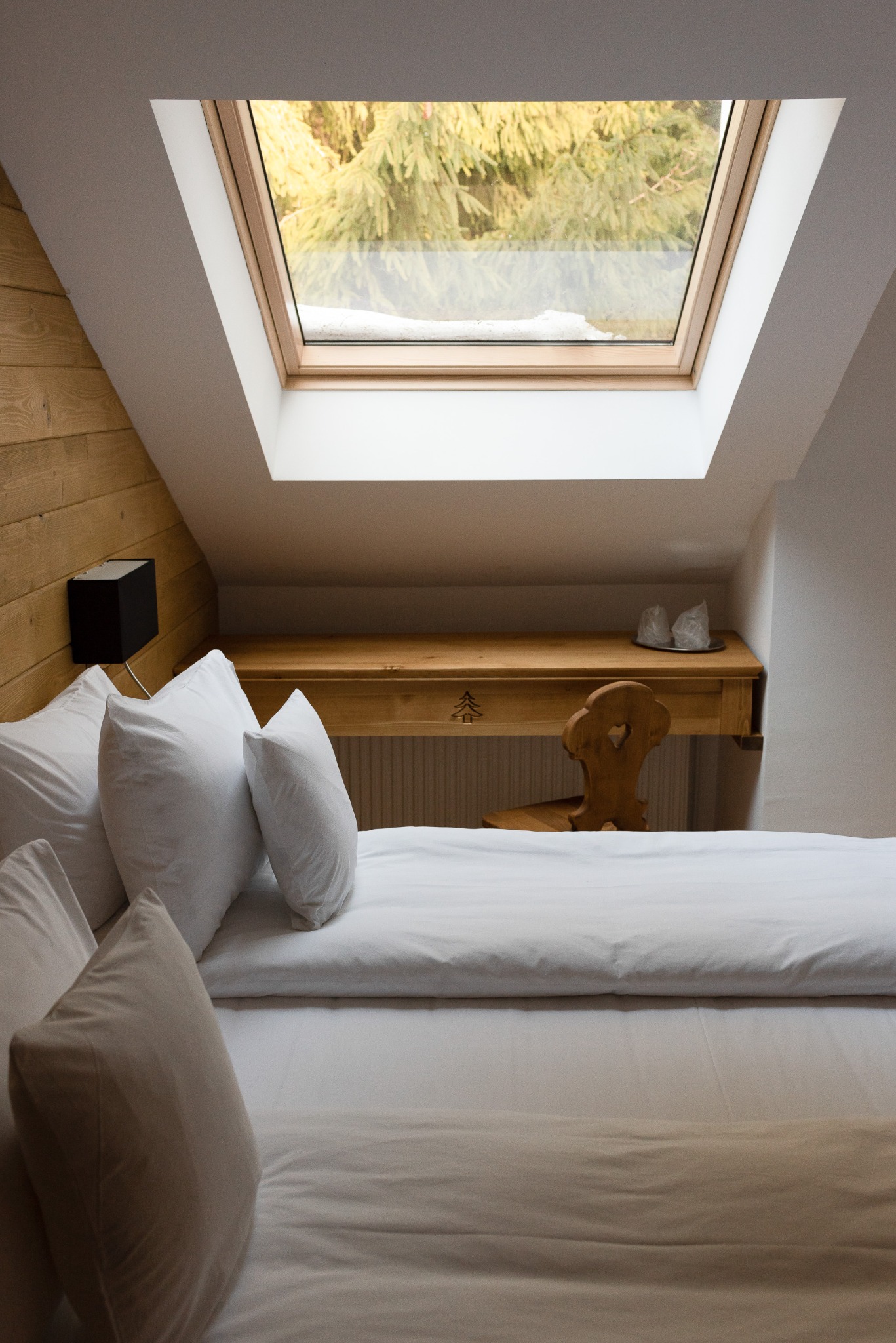 Attic bedroom beneath a skylight