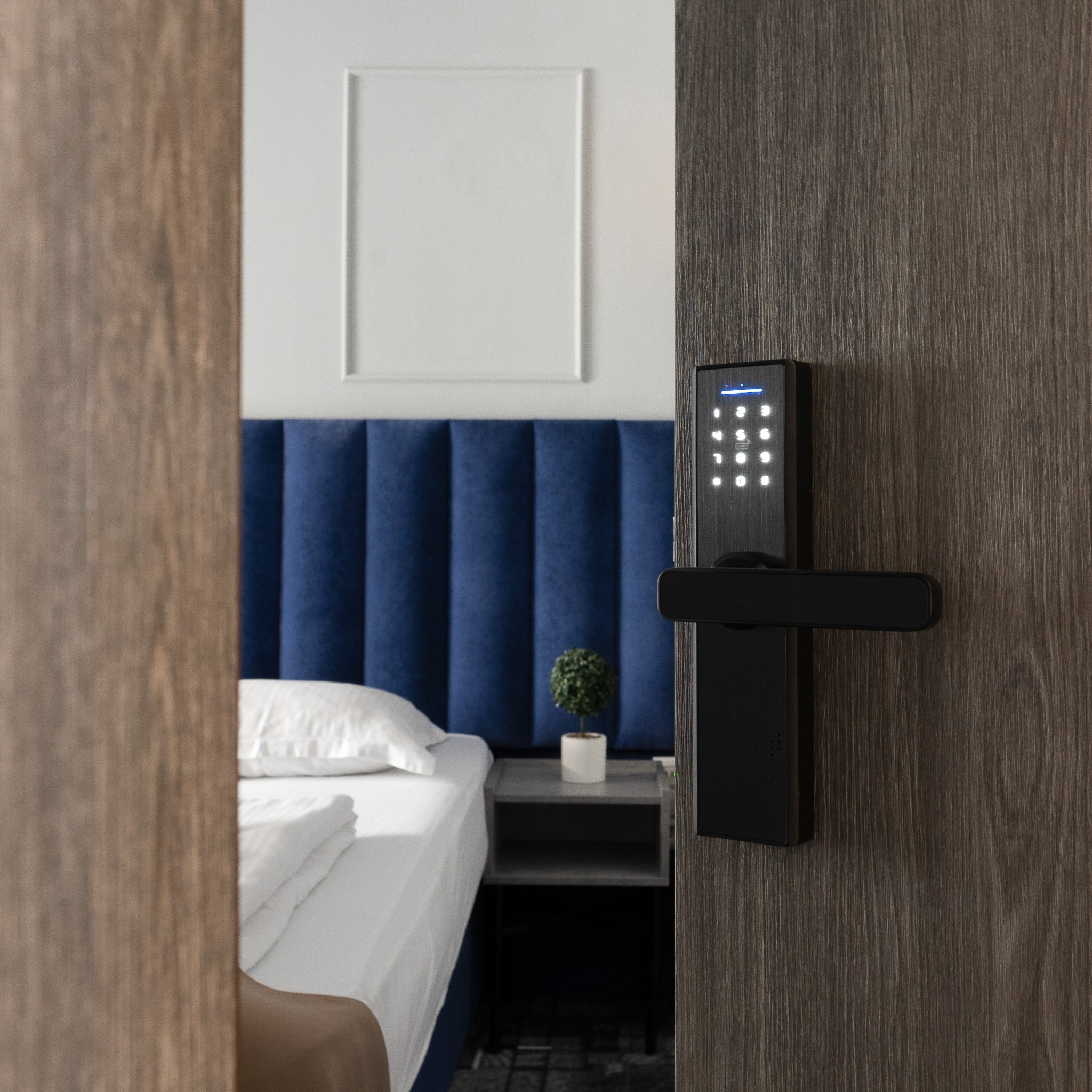 Door lock and mirror reflecting the blue-accented bedroom